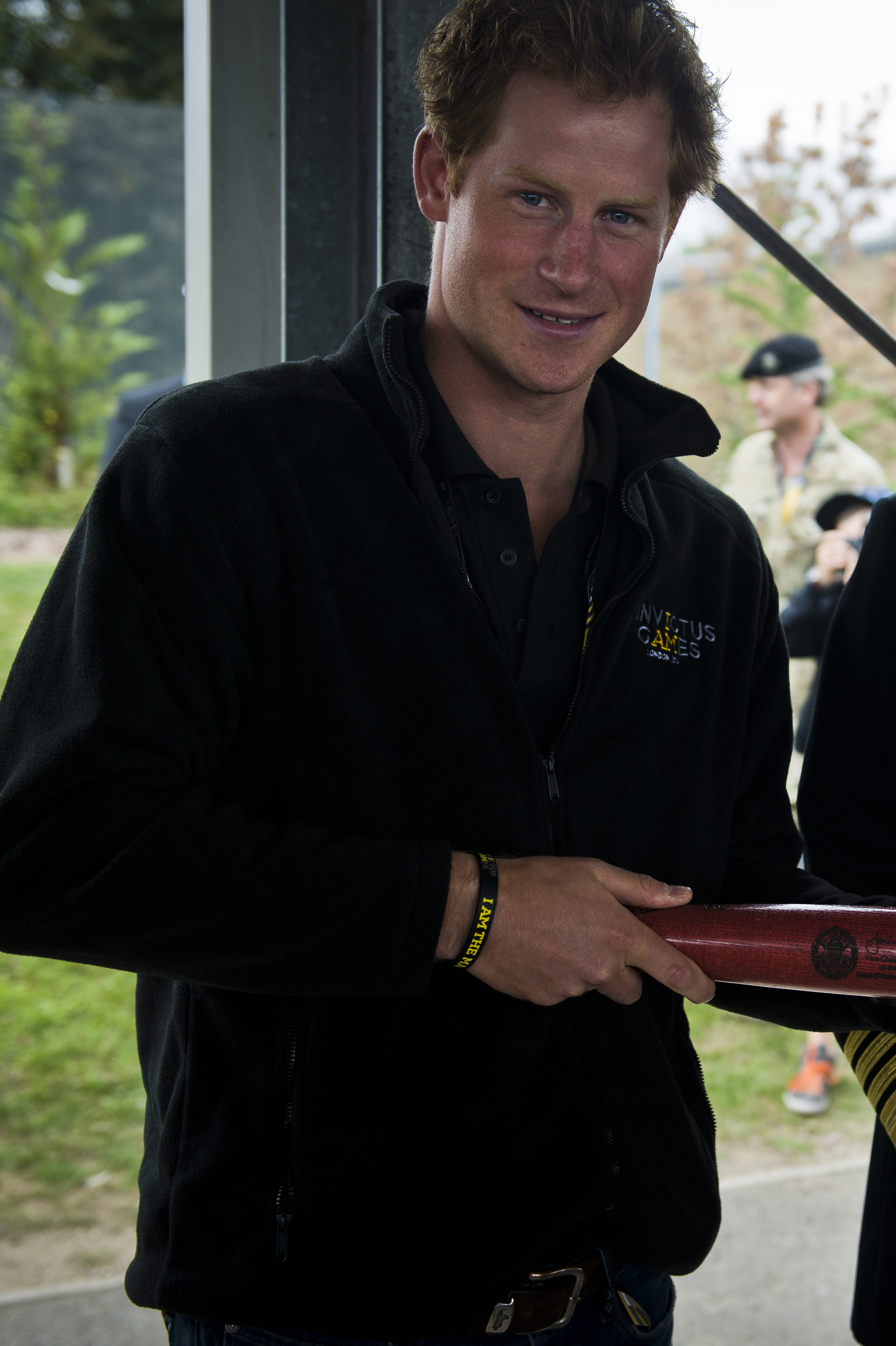 Prince Harry receiving a gift during an official visit in 2014