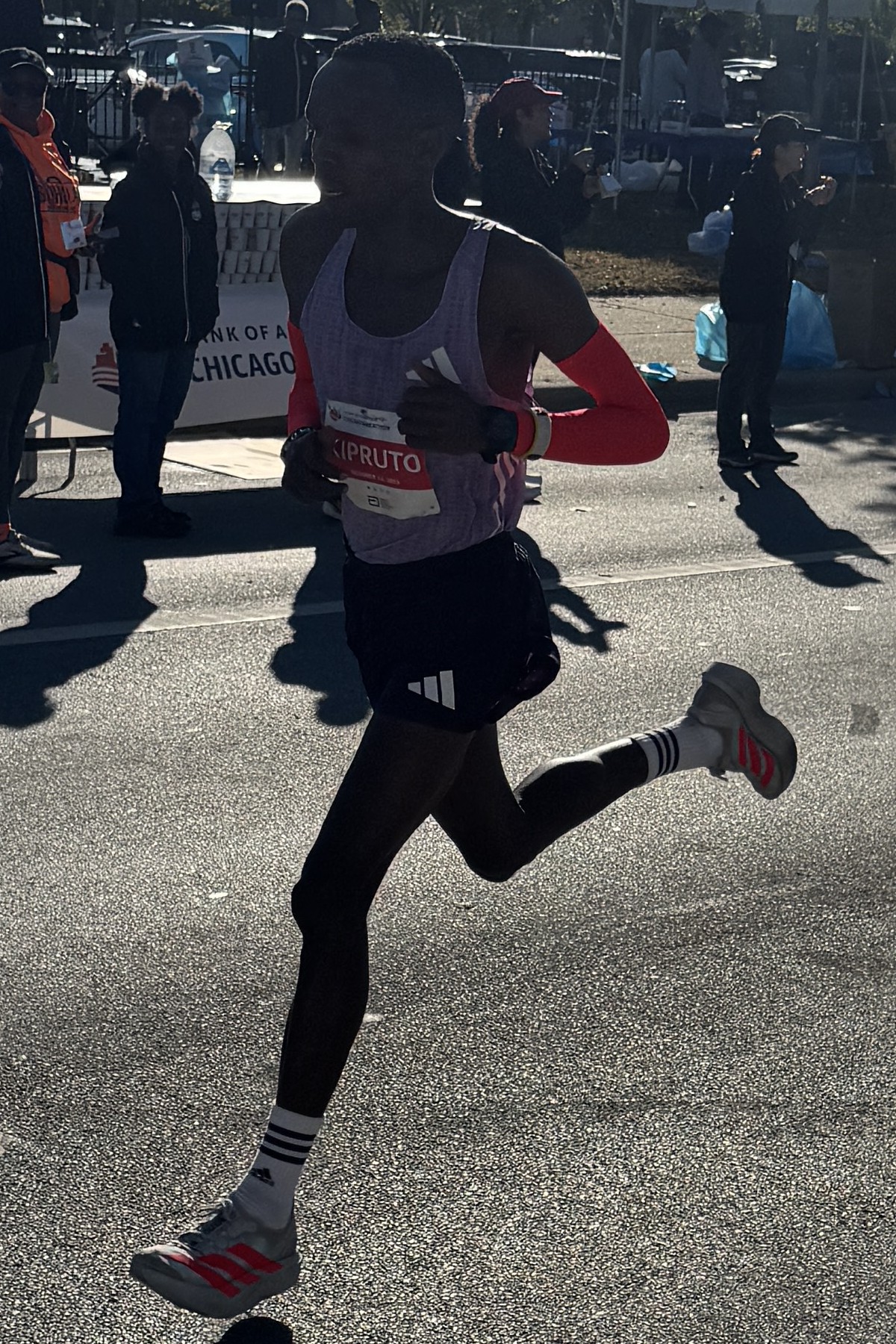 Runner mid-stride during a marathon on a city road