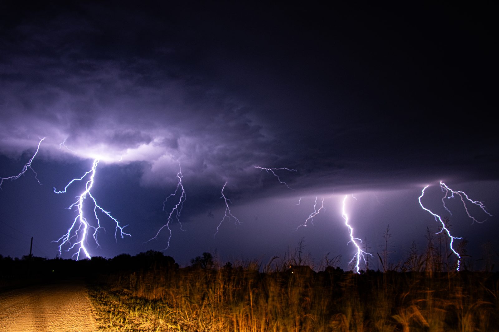 Three lightning strikes captured in a single long-exposure photograph at night