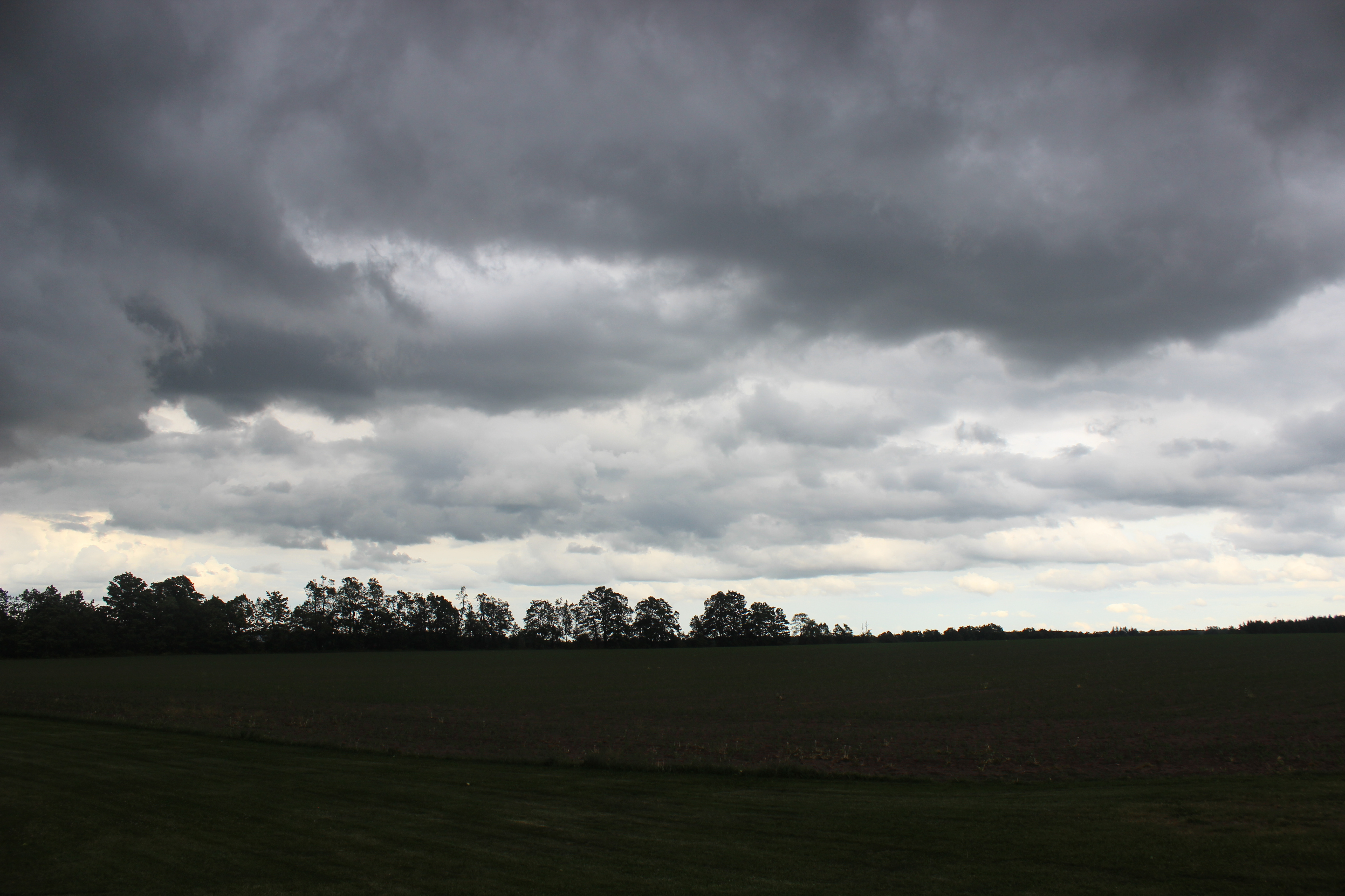 Dark thunderstorm clouds building over the landscape before a storm