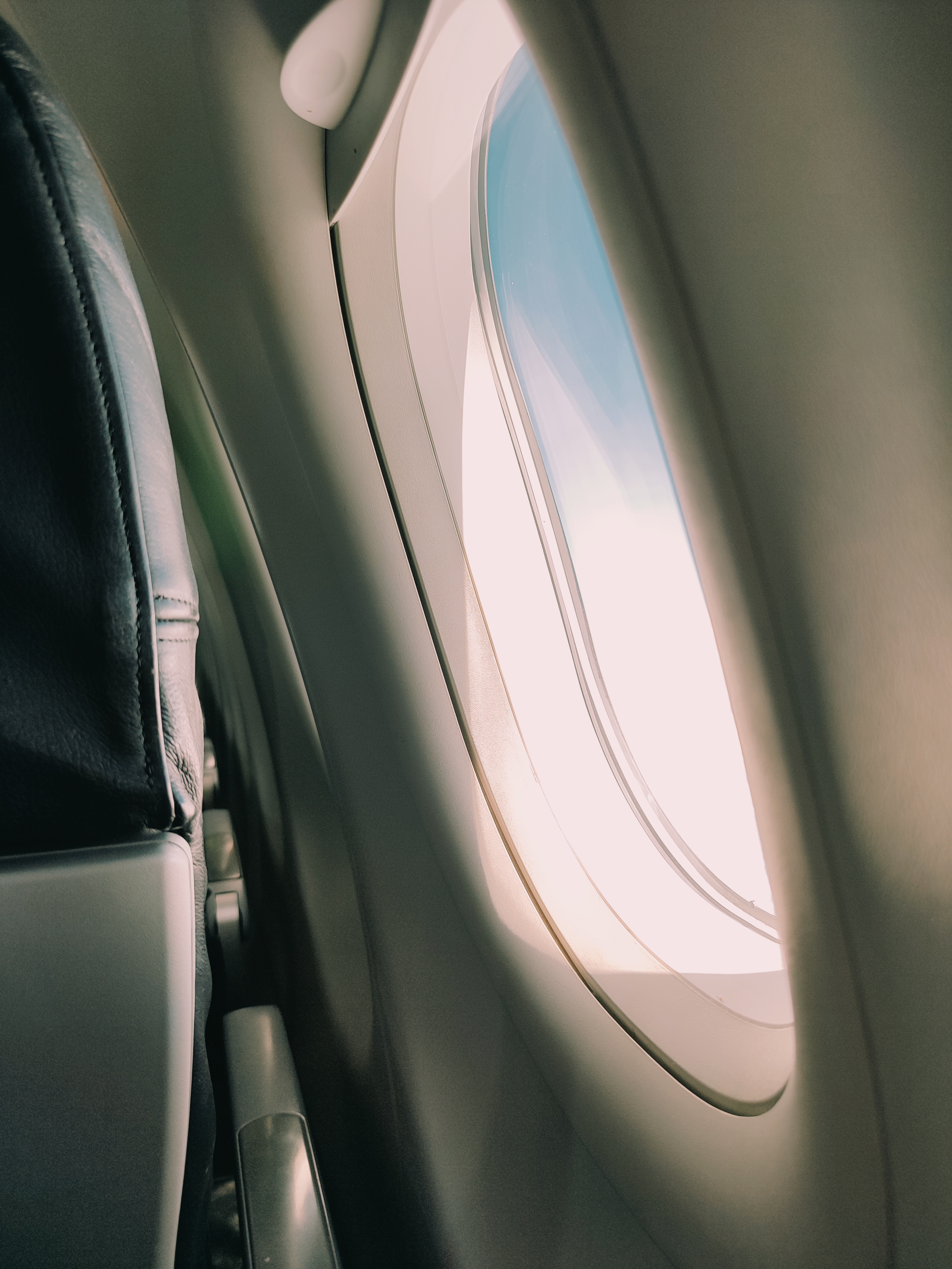 A passenger window seat inside an aircraft cabin