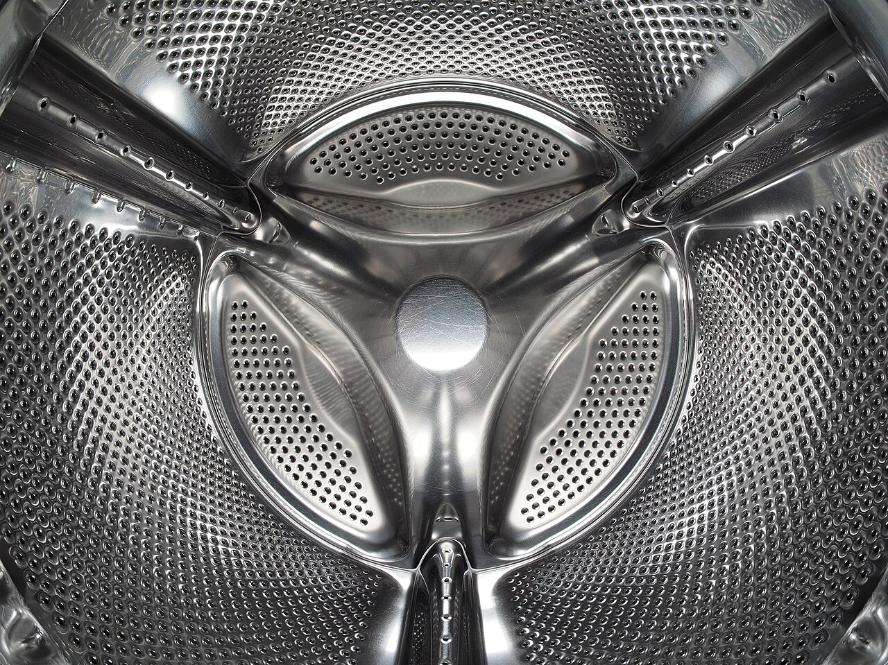The inside of a stainless steel washing machine drum, where residue builds up out of sight