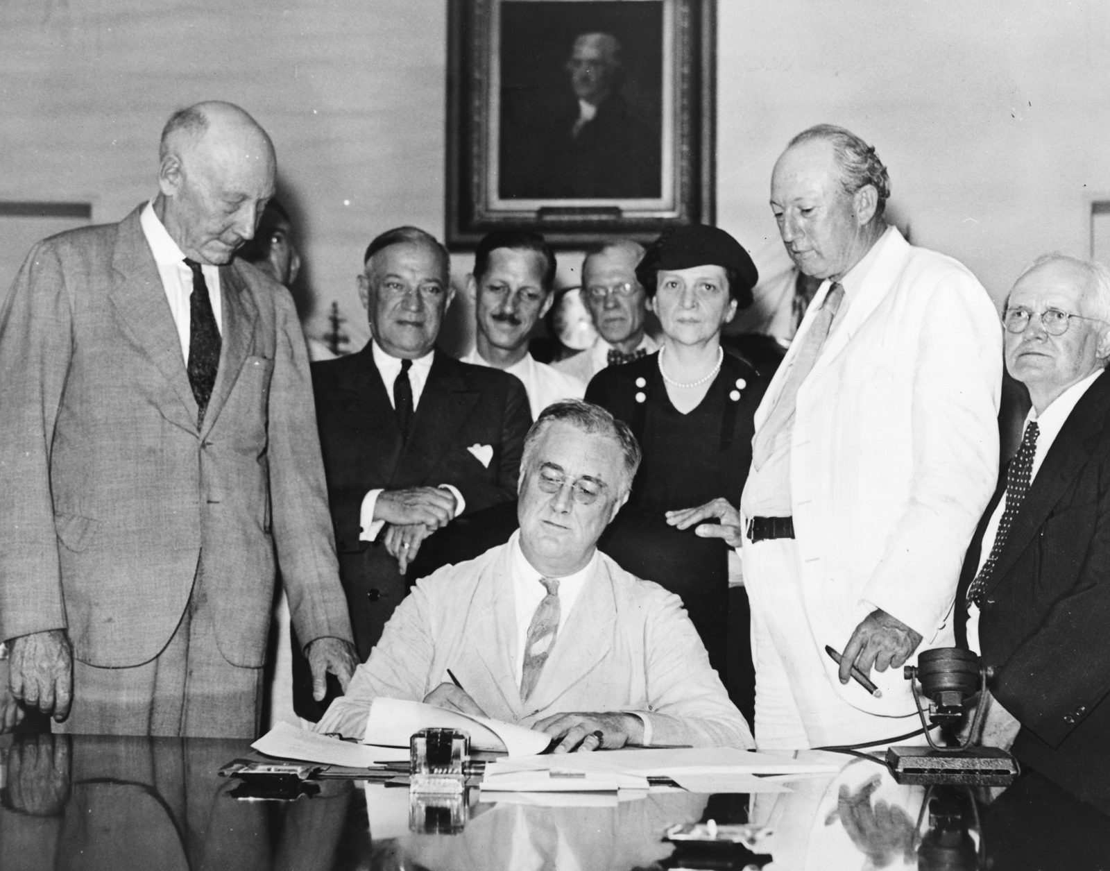 President Franklin D. Roosevelt signs the Social Security Act in 1935